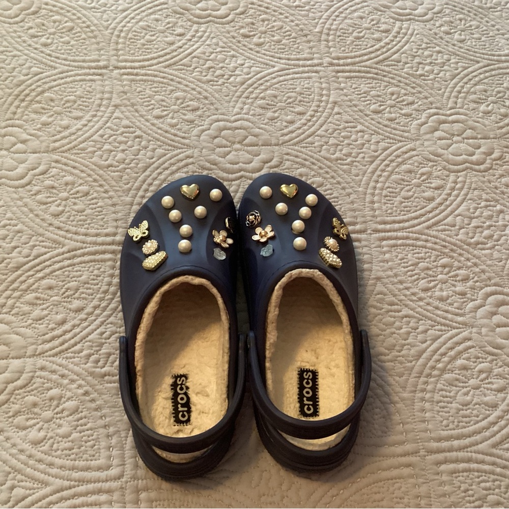 Womens' Navy CROCS with hand selected charms. NWOT. Smoke and pet free home.